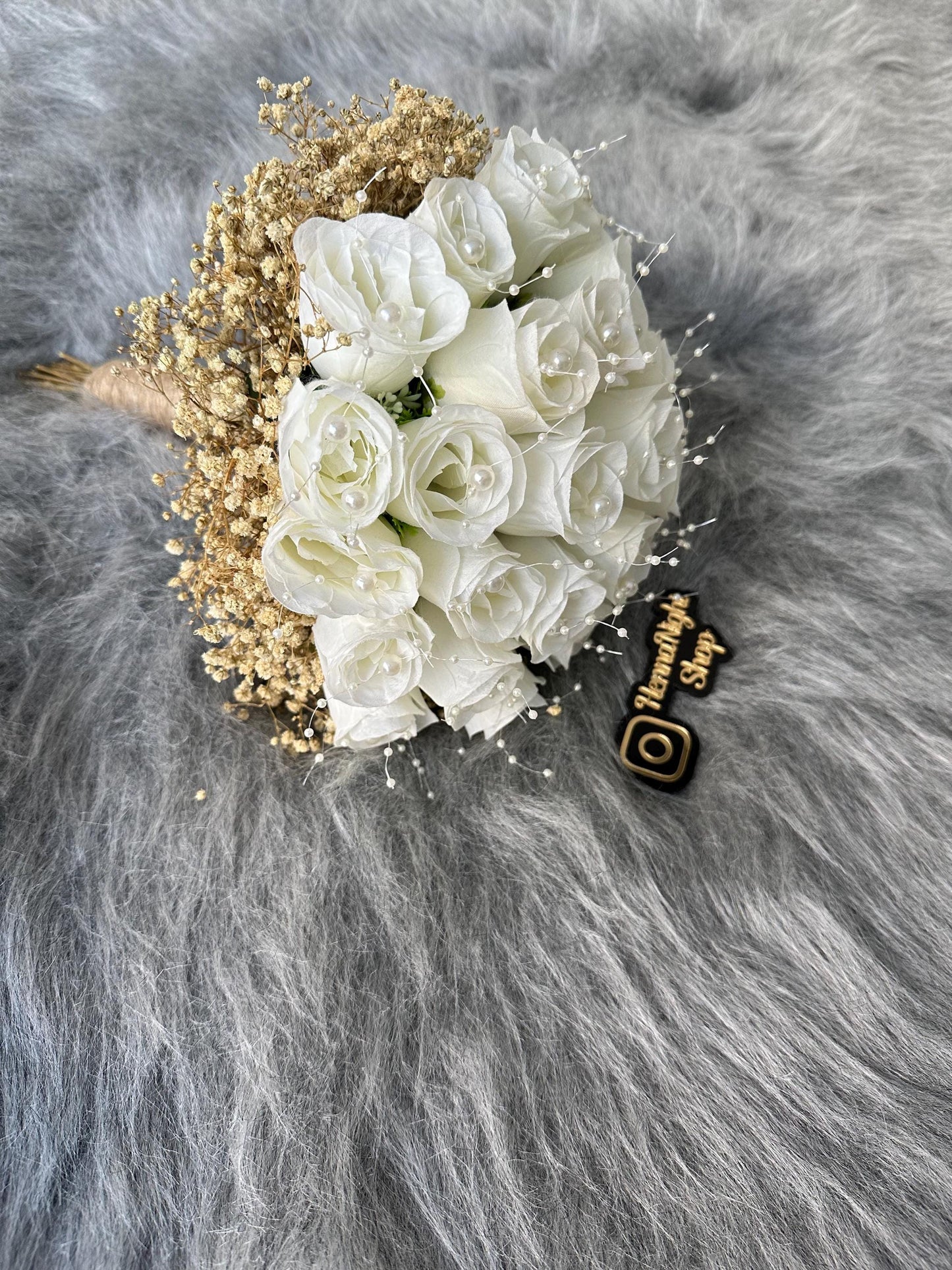 Beaded white rose bouquet for brides with elegant details.