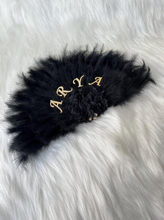 black feather fan with personalized name on it