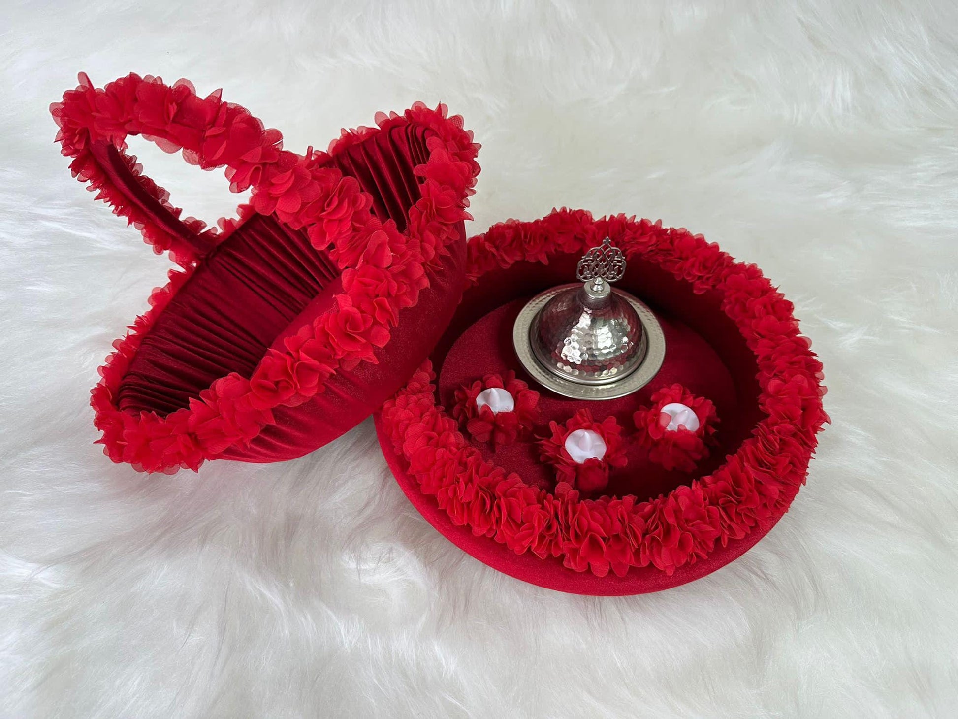 A henna basket with floral accents and henna tray with floral accents, there are three white led candles and henna silver iron dome inside tray
