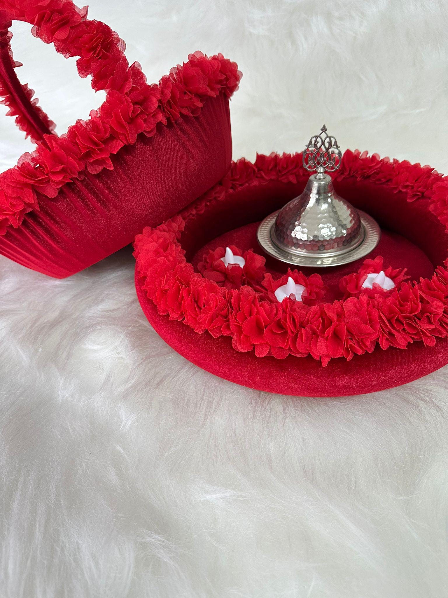 A henna basket with floral accents and henna tray with floral accents, there are three white led candles and henna silver iron dome inside tray