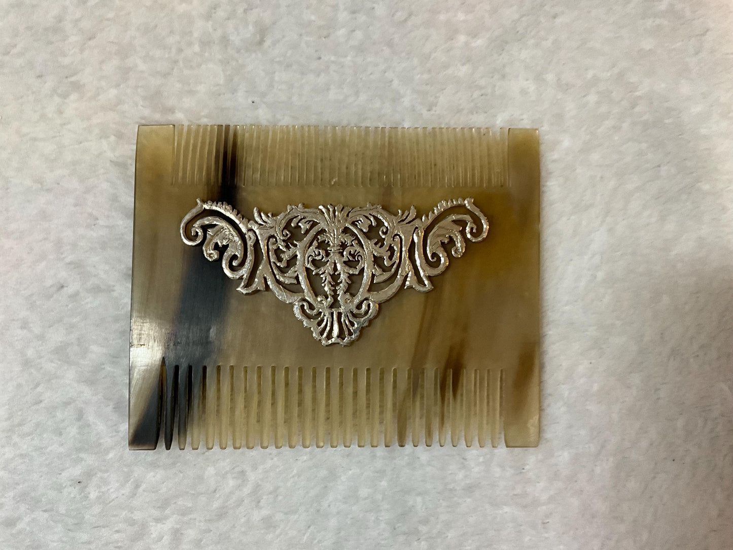 natural horn material comb with silver iron design front photo