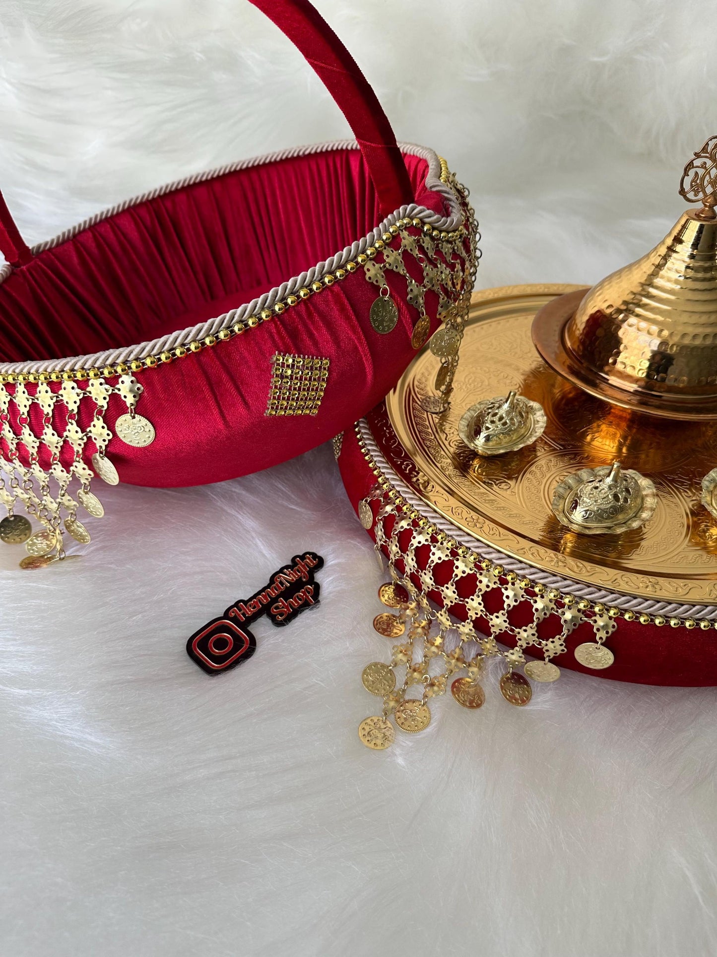 henna  A red velvet basket with a gold handle and gold trim. The basket is decorated with gold coins and a gold tassel. The basket is sitting on a gold tray with a gold lid. The tray is also decorated with gold coins and a gold tassel. The tray is sitting on a white fluffy surface. The text 'HannaNight Shop' is visible on the image.