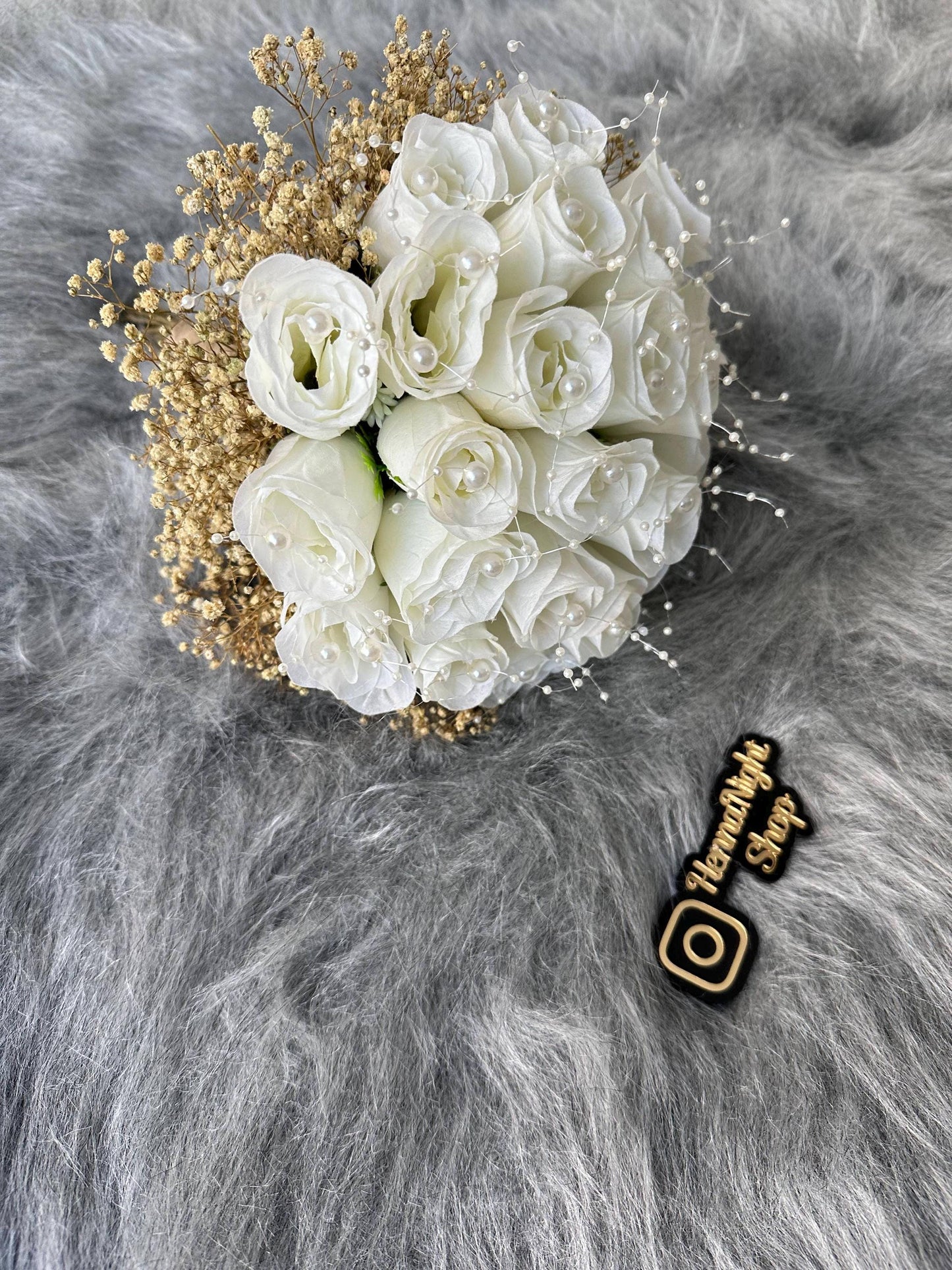 Beaded white rose bouquet for brides with elegant details.