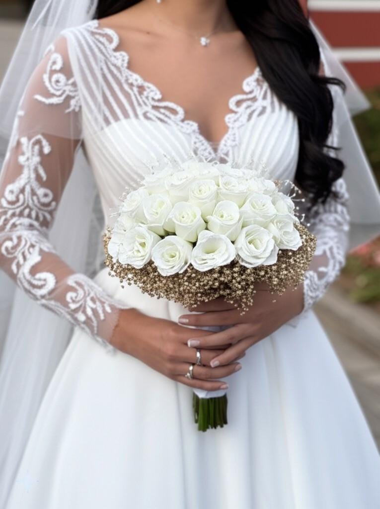 bir gelin, gelin cicegi tutuyor